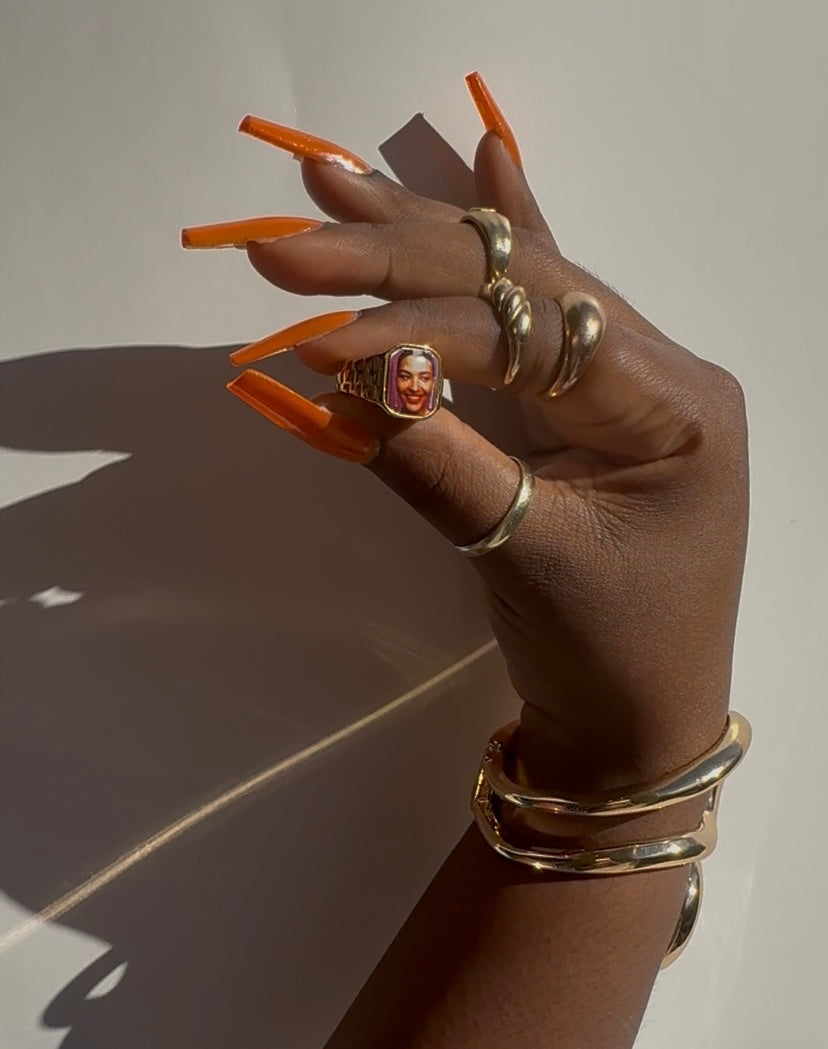 Hand holding an Olivia Dean-inspired Lav Vintage promise ring, styled in natural sunlight.