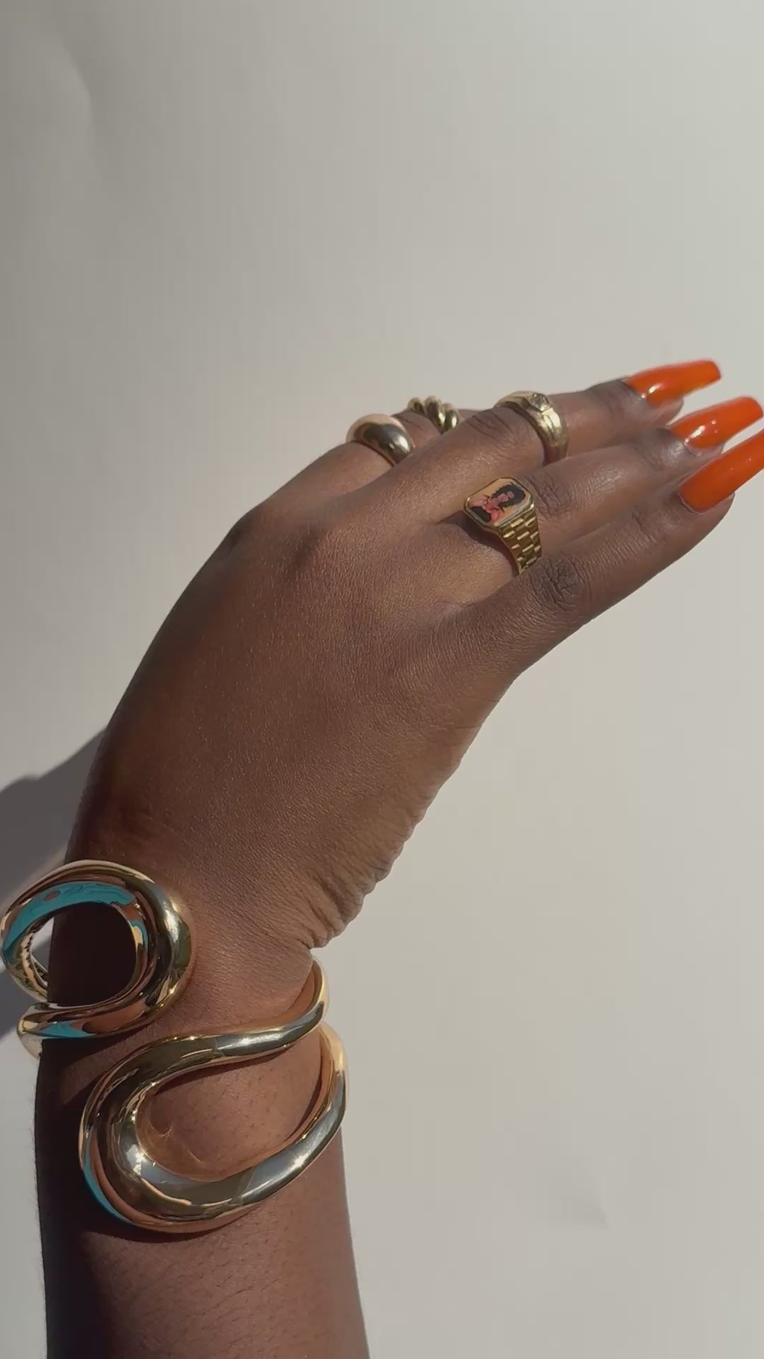 Video showing hand wearing stacked gold rings including a Lauryn Hill-inspired Lav Vintage promise ring, styled in natural sunlight.