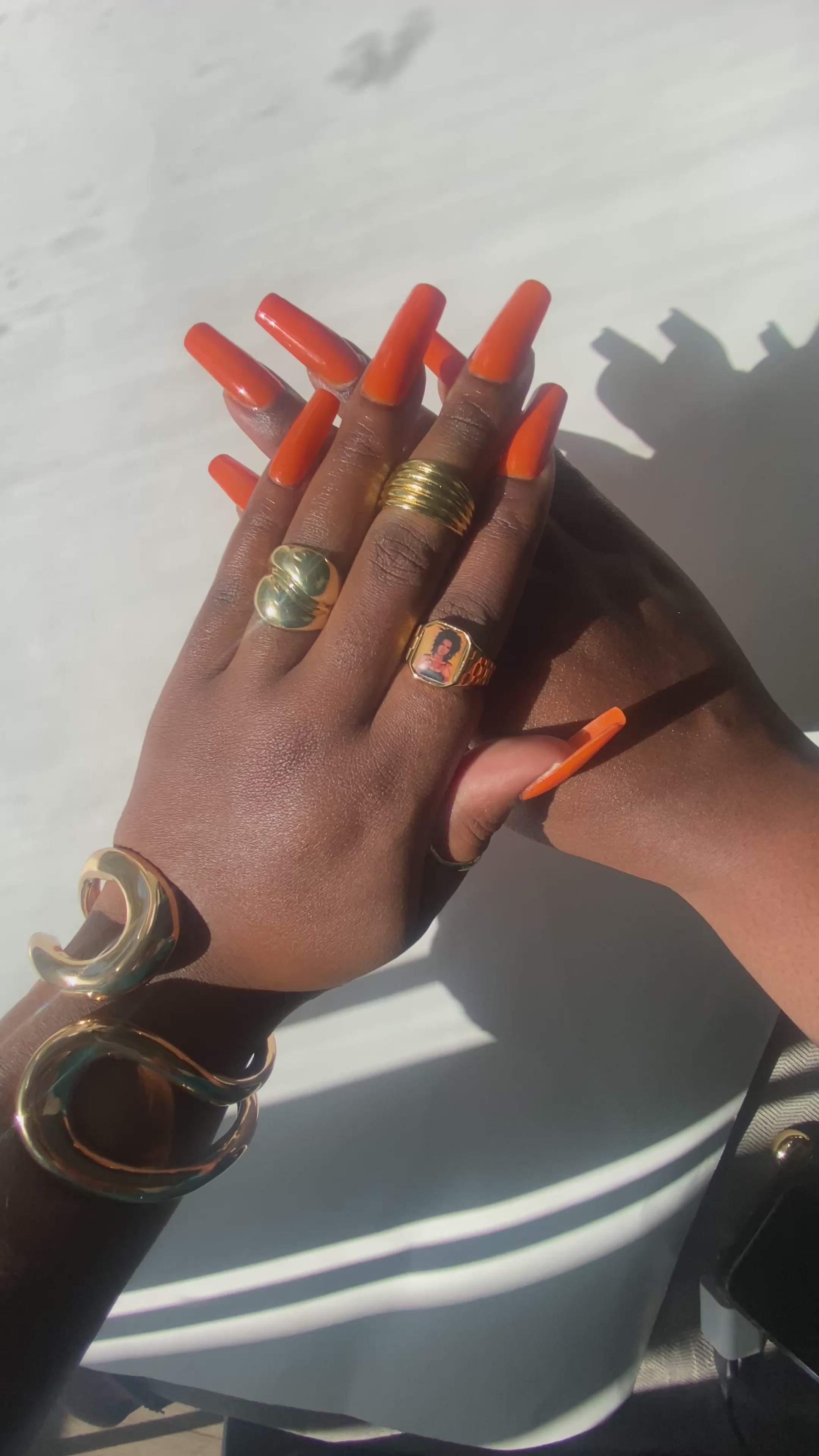 Video showing hand wearing stacked gold rings including a Lauryn Hill-inspired Lav Vintage promise ring, styled in natural sunlight.